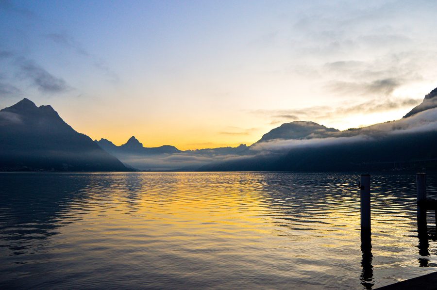 Lever de soleil sur le lac des Quatre-Cantons près de Beckenried avec des montagnes à l’arrière-plan.